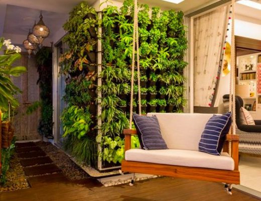 A cozy and vibrant balcony with greenery and a swing
